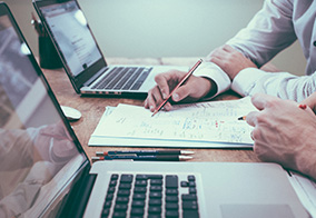 Business Succession planning: Two professionals reviewing documents.